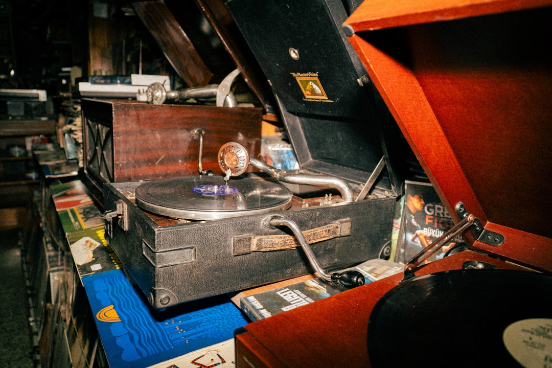 Vinyl record collection with turntable setup and album covers on display shelf
