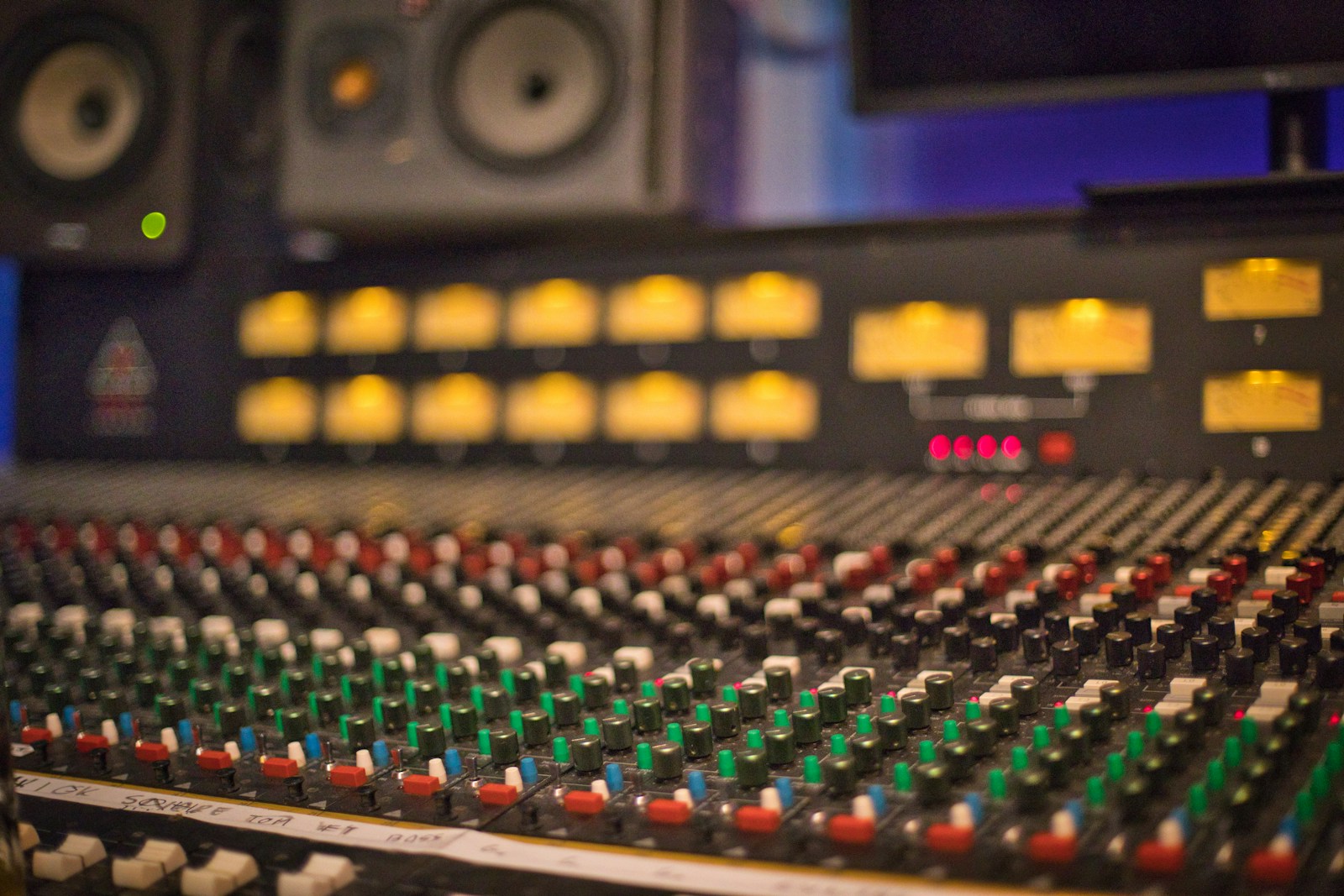 An Ampex MM1200 2-inch tape machine next to a modern Pro Tools HDX rig, photographed in a hybrid mixing room