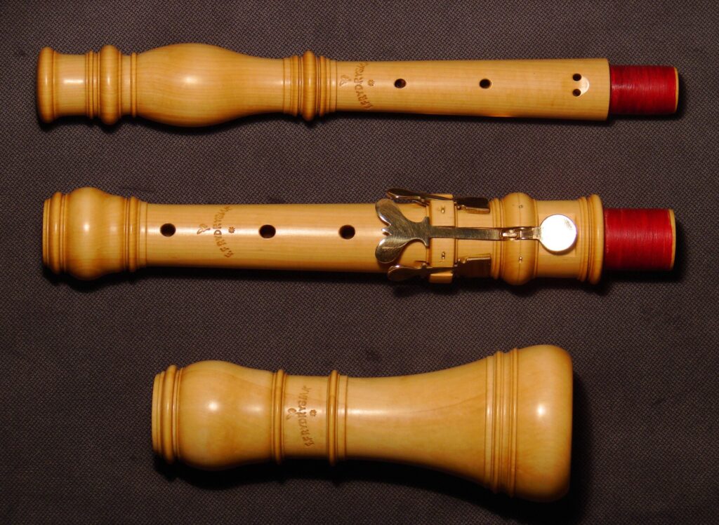 Hautbois baroque en bois posé sur un tissu sombre, clés et tenons apparents